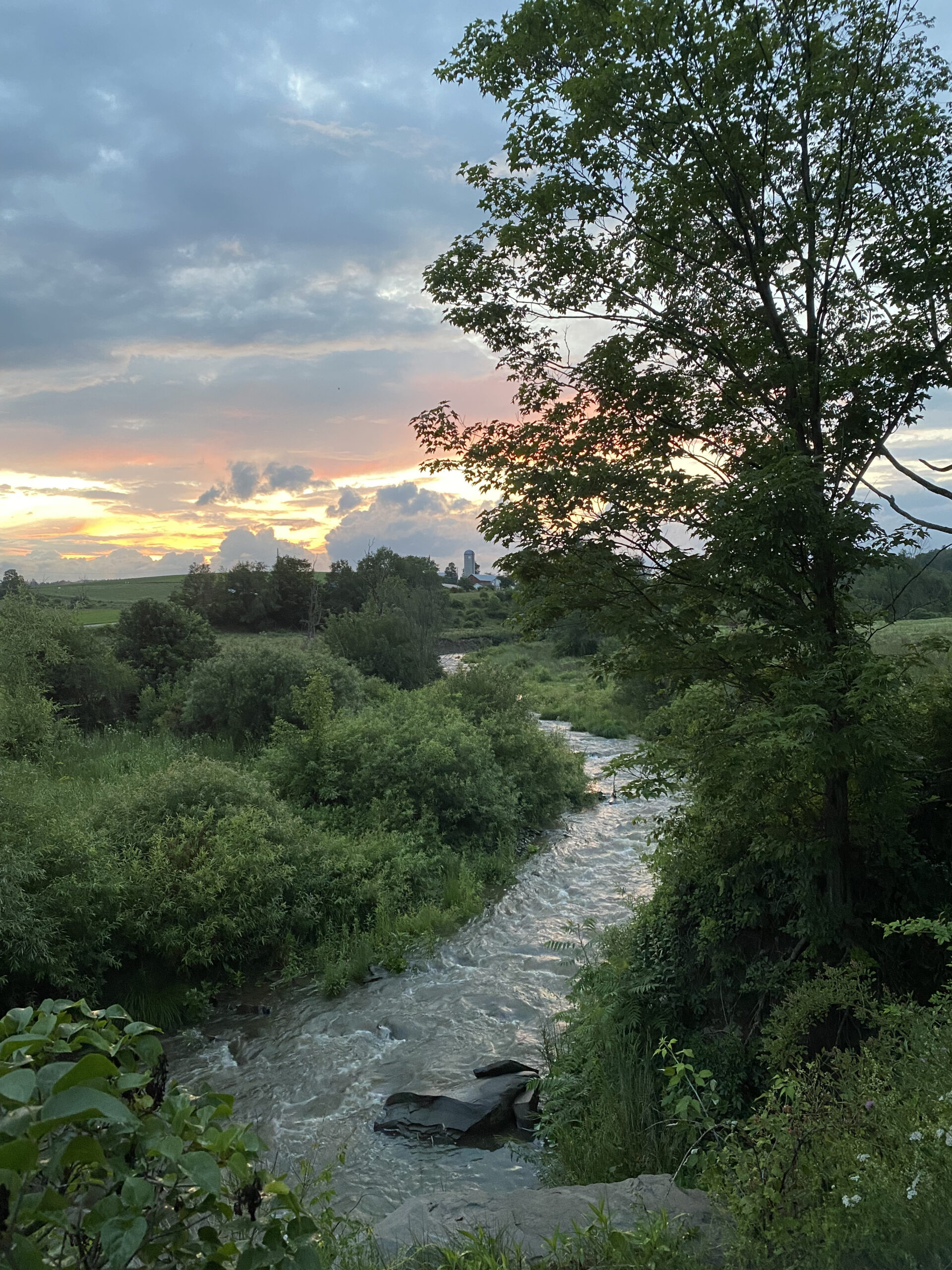 beautiful country scene with creek and sunset
